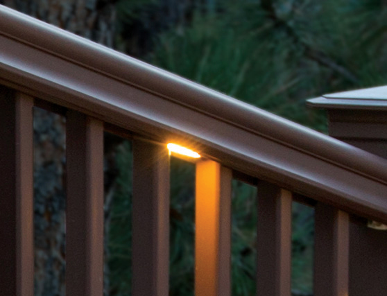 A light installed under a deck railing